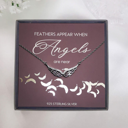 sterling silver double angel wing pendant necklace.  boxed with handmade foiled insert with the quote "feathers appear when angels are near".  Unique memorial gift for loss, sympathy, remembrance gift.