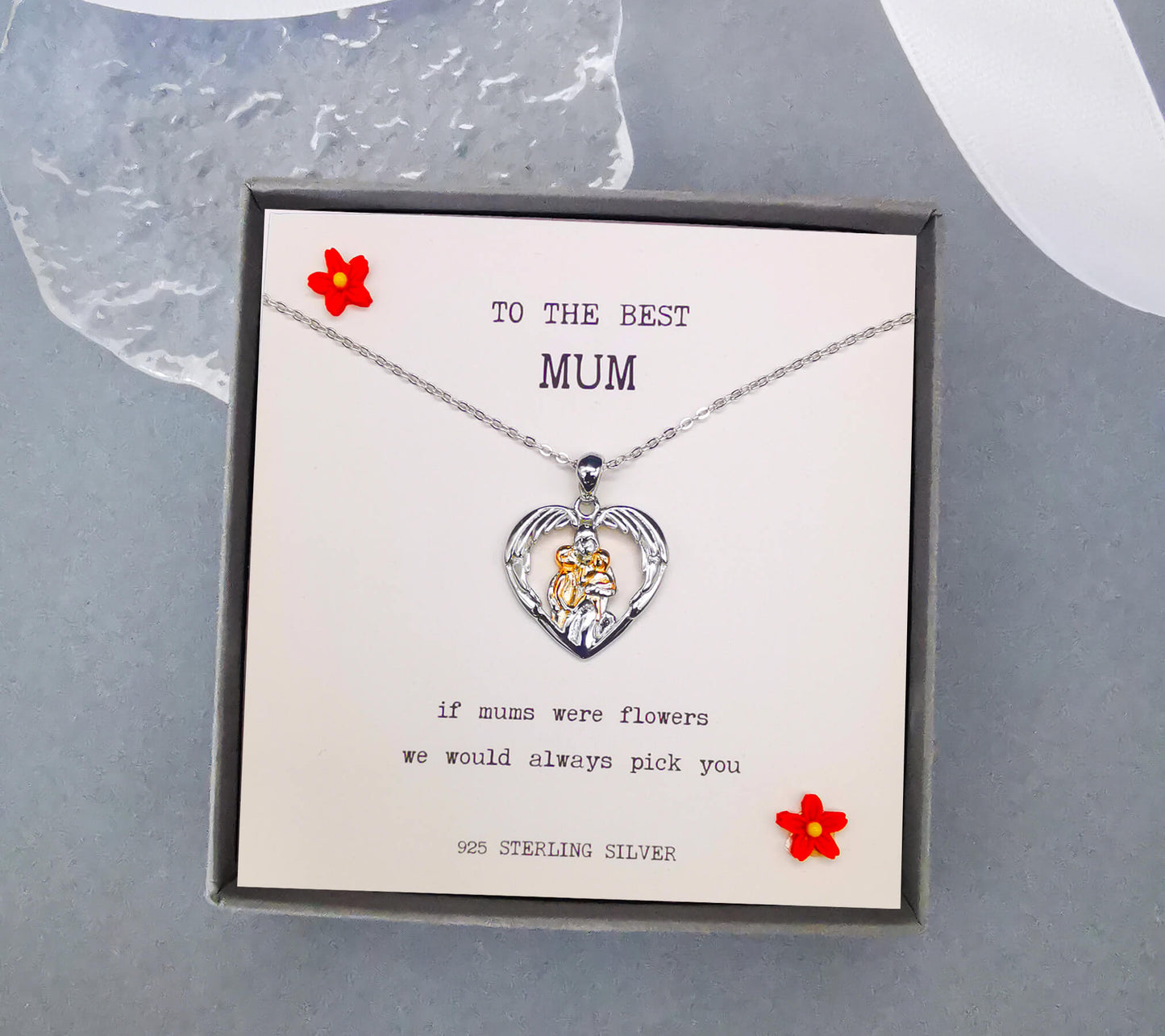 Sterling silver and rose gold necklace depicting mum hugging two children in wings. Features the quote "if mums were flowers we would always pick you". Comes boxed with quote insert. White insert. 